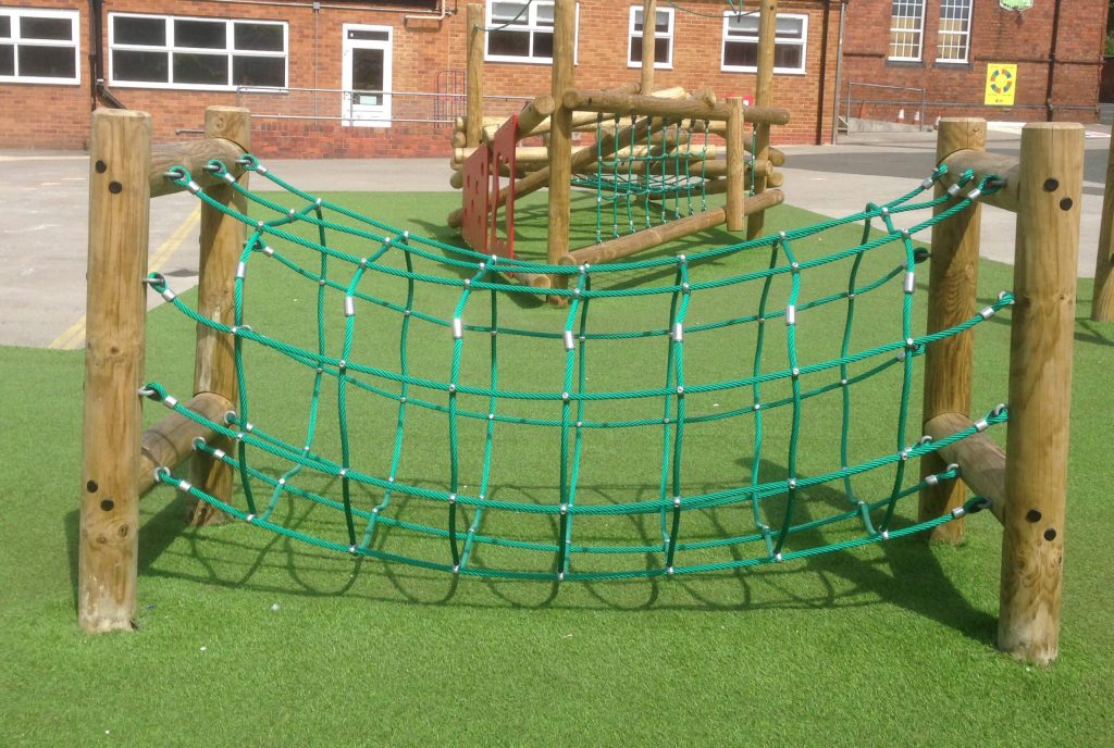 wooden trim trail item rope tunnel installed onto artificial grass surfacing