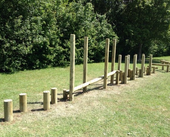 stepping logs and wooden balance beam which creates a balancing trail in a school