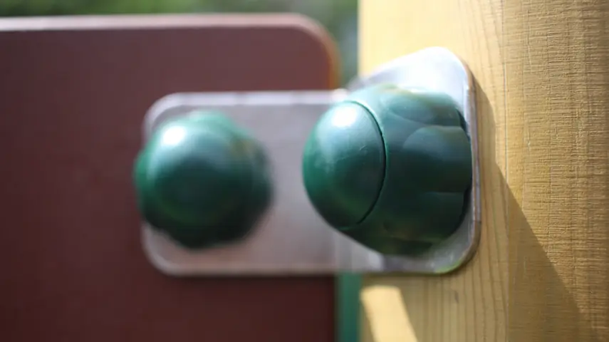 close-up of rubber safety end caps on climbing frame bolts