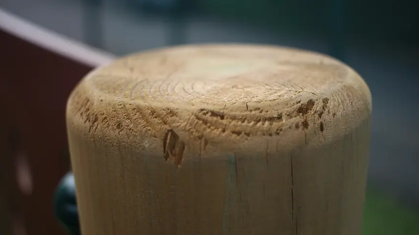close-up of a wooden play post showing grain and end grain finish