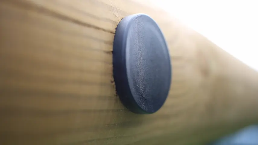 rubber safety cap fitted to wooden play equipment post