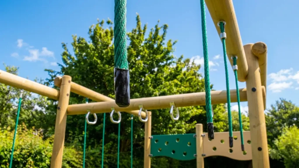 climbing frame with rope handholds and cargo net panels
