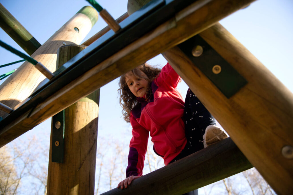 child climbing timber active play equipment
