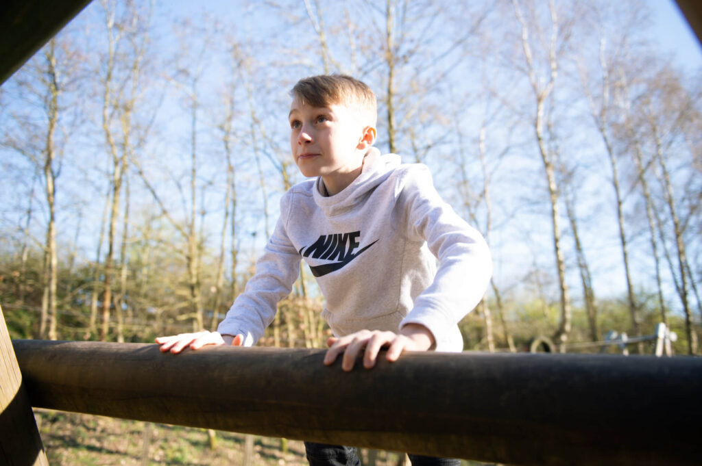 child climbing timber active play equipment