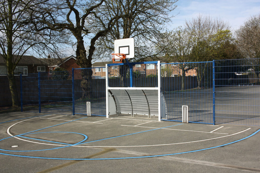 Multi Use Gym Area with basketball net, hockey or football goal, play markings and fence