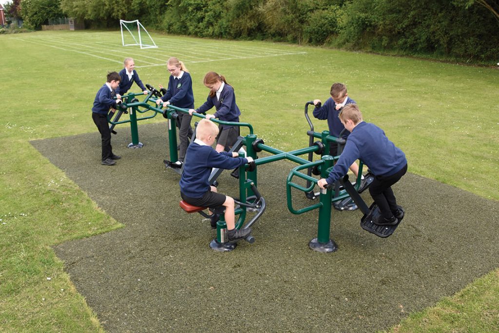 Children using an outdoor gym combination set with a range of fitness activities