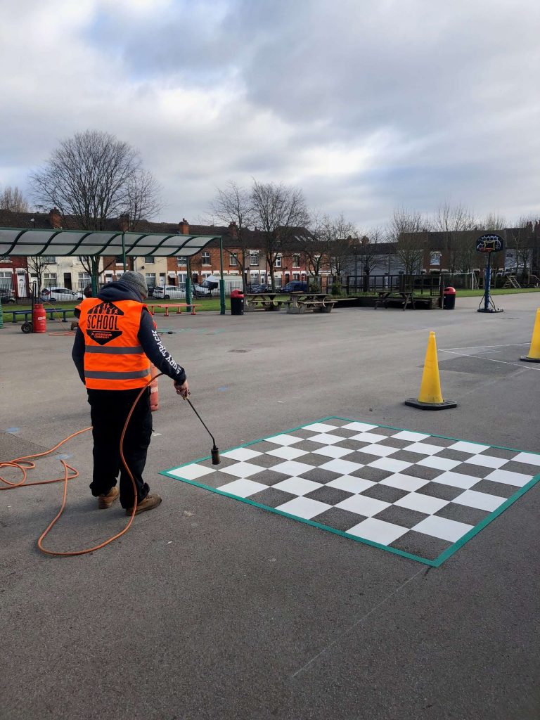 School Playground Company repairs and upkeep on chess board playground markings- playground installation