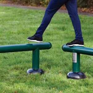 child stepping on balance beams in outdoor gym equipment package for kids