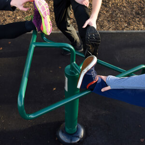 children using leg stretch triangular stand outdoor gym equipment component