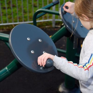 child using tai chi rotating disks outdoor gym equipment for kids