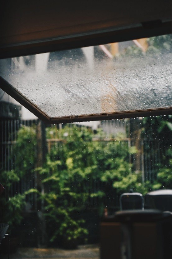 Rain dripping from a clear roof canopy