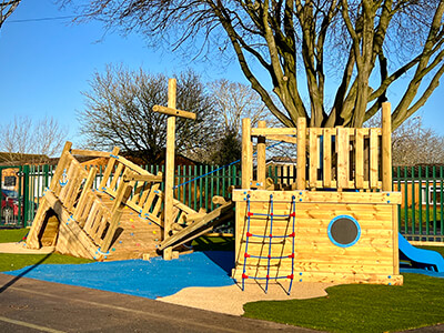 Shipwreck themed creative play structure with climbing net