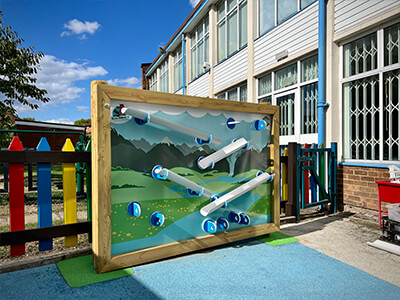 Giant water wall sensory and creative play panel with white tubing and nature-themed background design