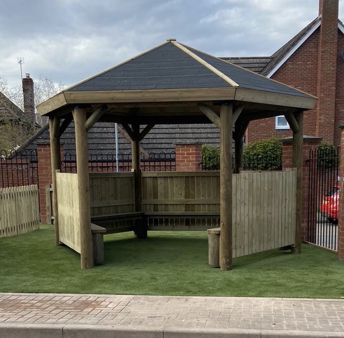 Wooden hexagonal gazebo on artificial grass