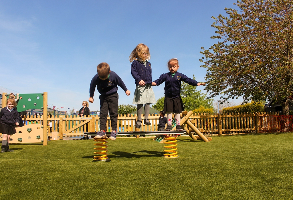 Children jumping on springing balance beam