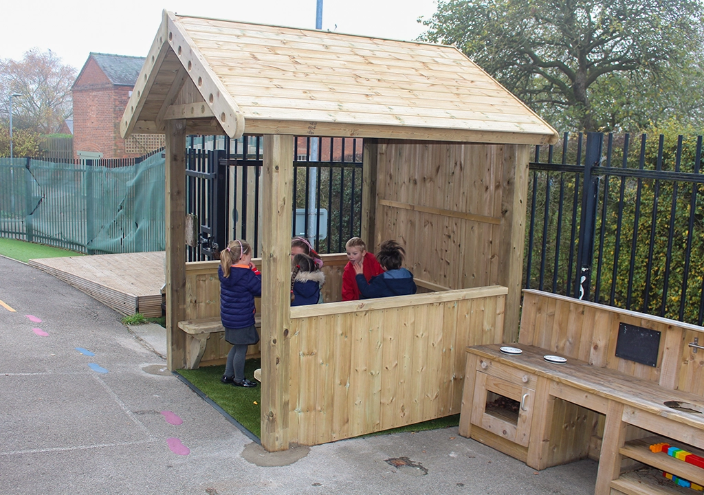 children in a wooden play house style square gazebo
