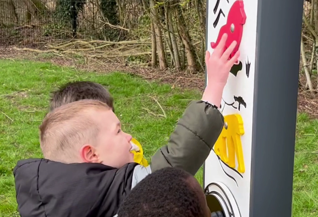 child playing with animal themed educational play panel