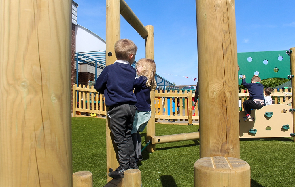 Play on wooden playground equipment for school children - trim trail equipment