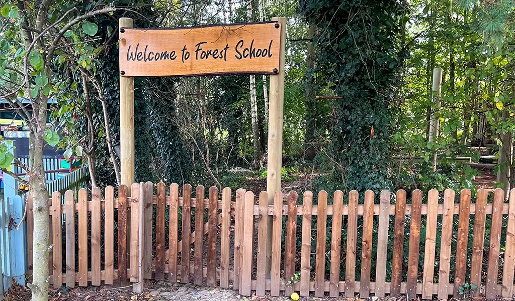 Sign on a fence reading: “Welcome to Forest School"