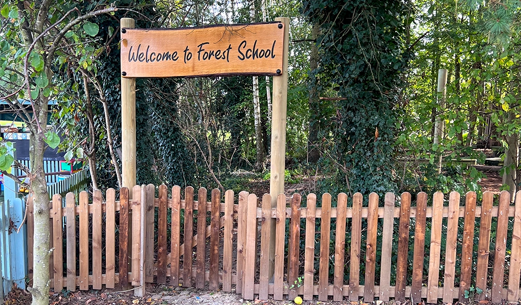 Sign on a fence reading: “Welcome to Forest School