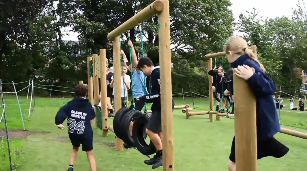 Children playing on trim trail active play equipment in a Nottinghamshire school