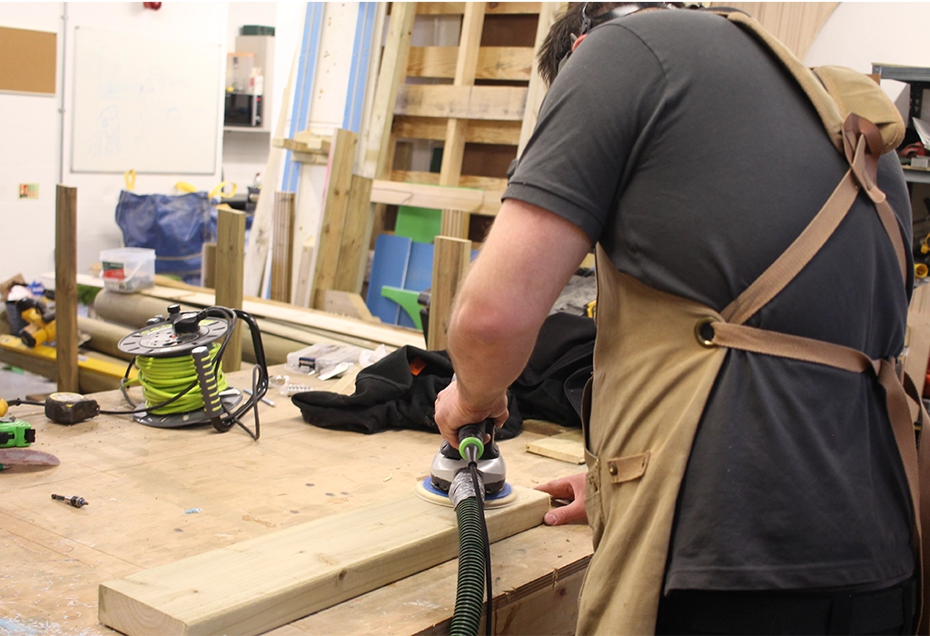Wood plank sanding in The School Playground Company Workshop