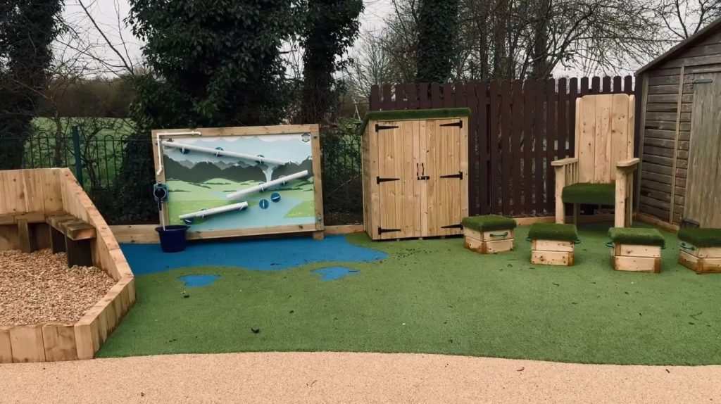 Seating area and water wall in sensory garden play area