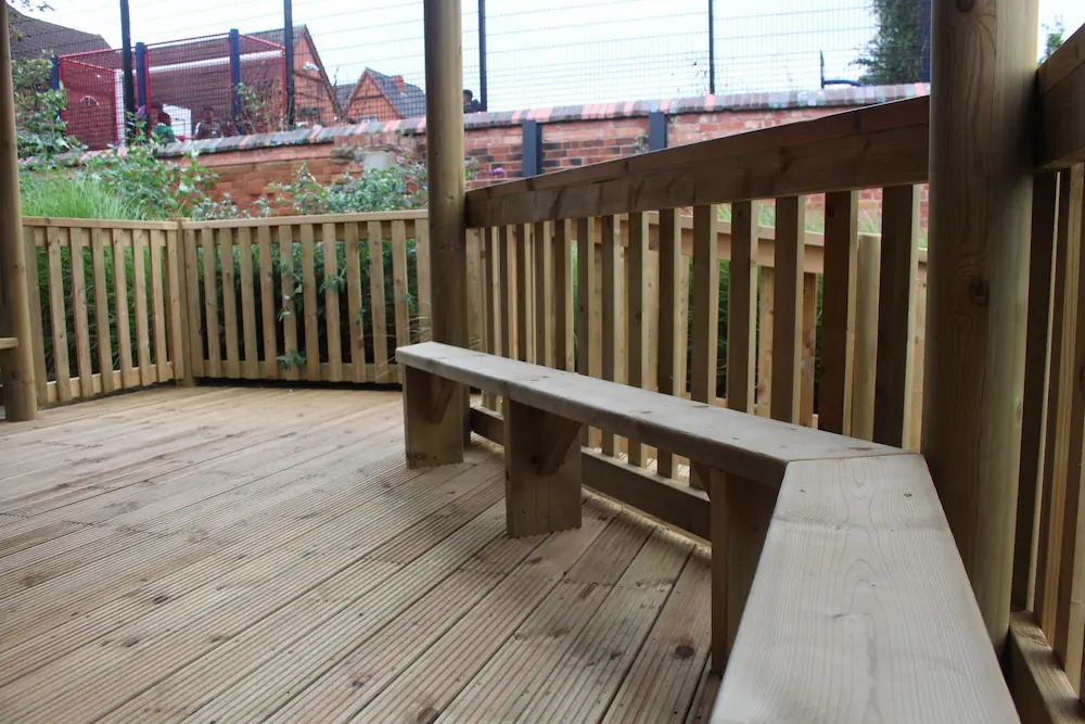 Wooden bench seating in outdoor classroom gazebo