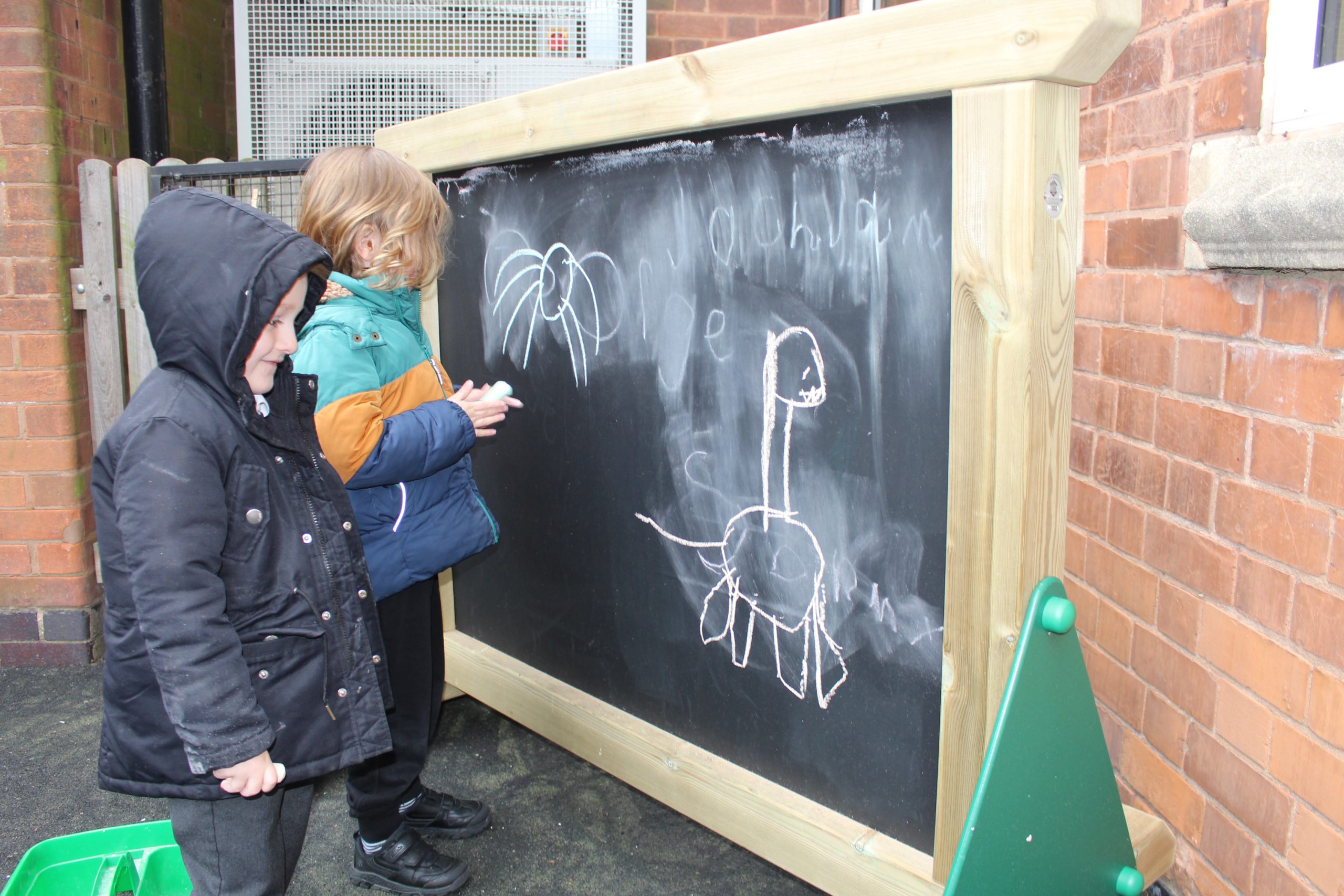 Children using freestanding chalkboard panel