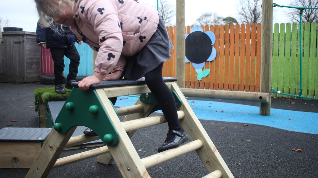 Child climbing down their trim trail A-Frame ladder