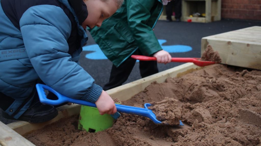 Close-up on Sand Pit being used, Wide