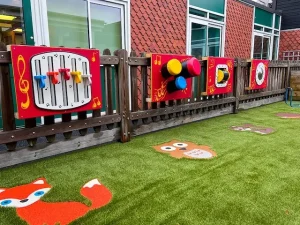 Musical Play Panels mounted on fence