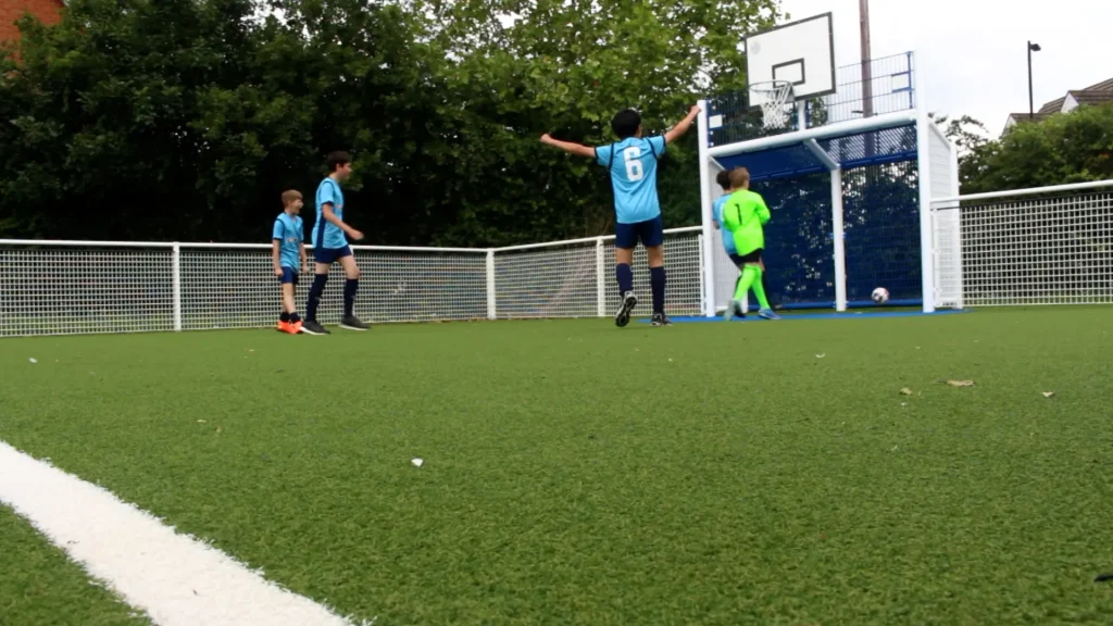 Children playing football on MUGA at Nene Valley