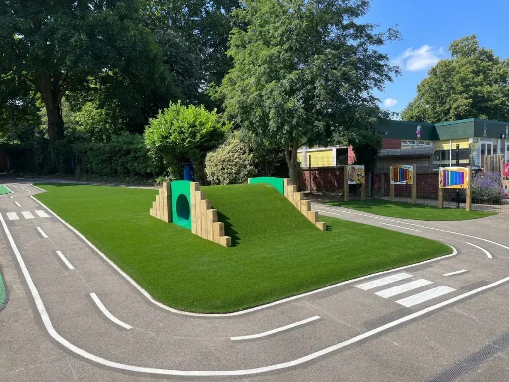 road safety trail with grass mound and tunnel outside school building