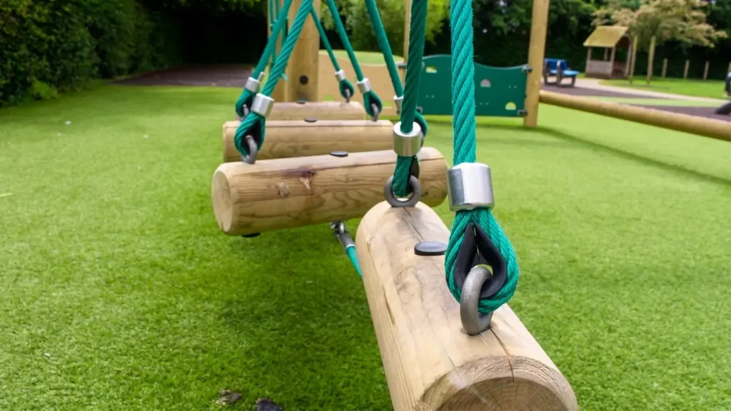 close-up of rope and log balance beam playground equipment