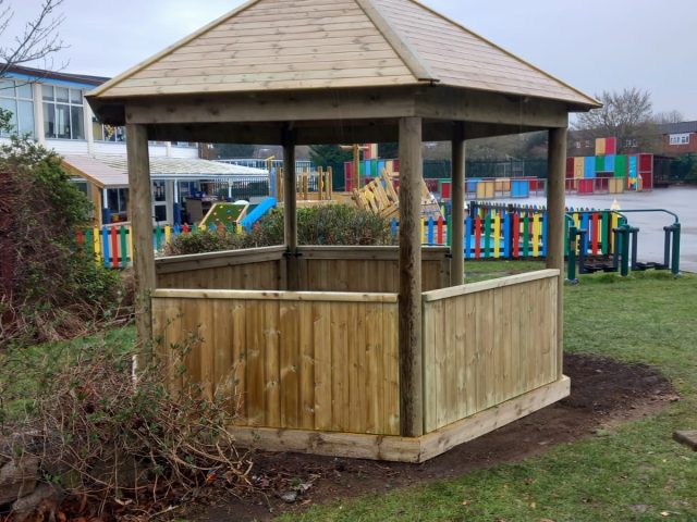 Hexagonal gazebo with artificial grass flooring