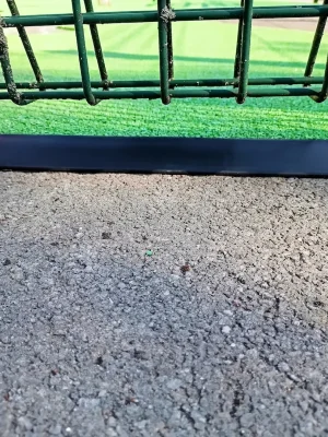 clean playground edging strip between tarmac and artificial grass