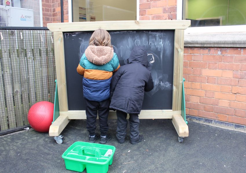 Children using freestanding chalkboard panel