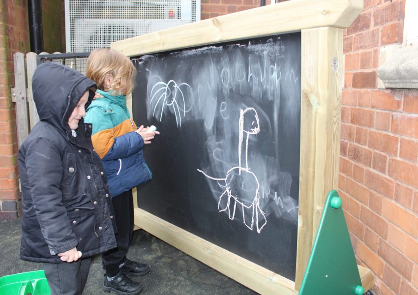 Children using freestanding chalkboard panel