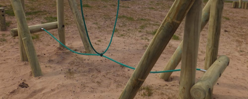 wooden trim trail item Burma Bridge installed onto play sand