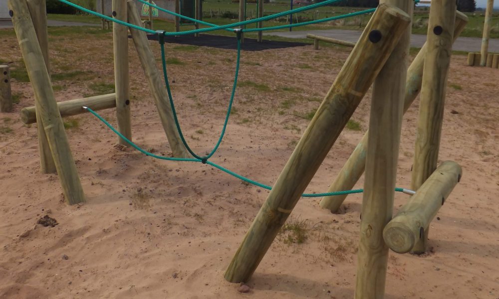 wooden trim trail item Burma Bridge installed onto play sand