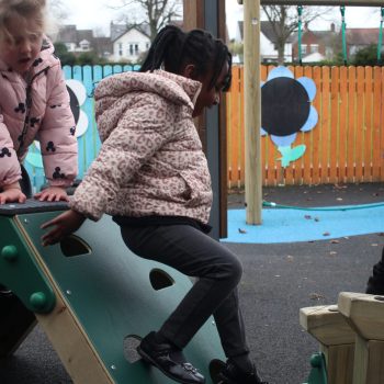 Child climbing down the A-Frame climb wall