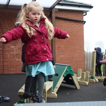 Child on crossing the trim trail balance beam