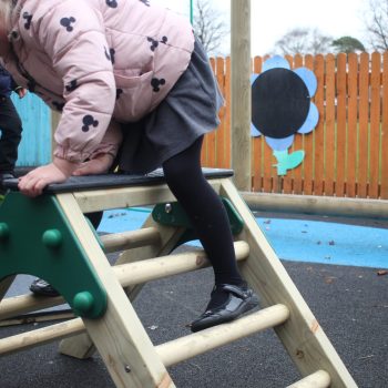 Child climbing down their trim trail A-Frame ladder