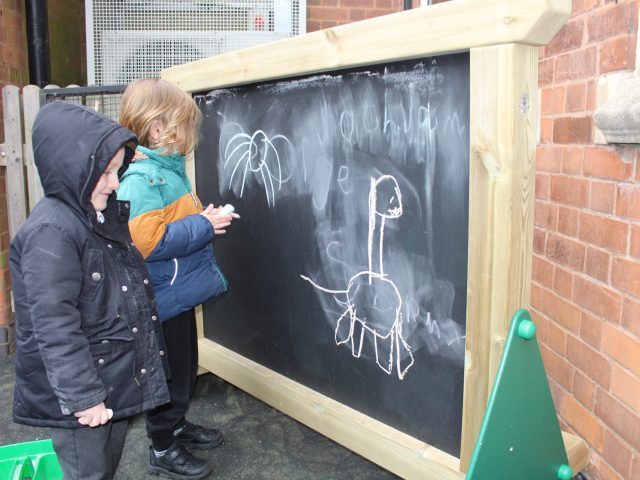 Children using freestanding chalkboard panel
