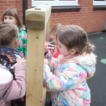 Children getting creative with the double-sided freestanding whiteboard