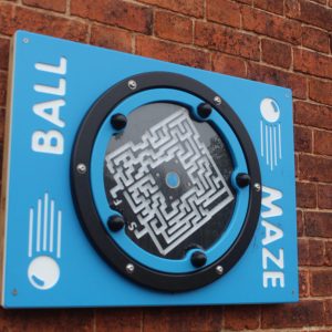Sensory play panel game called Ball Maze mounted on a wall at a Nottinghamshire school playground