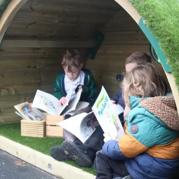 Children reading in their new Hobbit House Reading Den