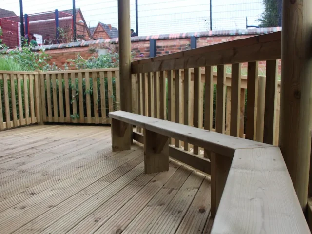 Wooden bench seating in outdoor classroom gazebo