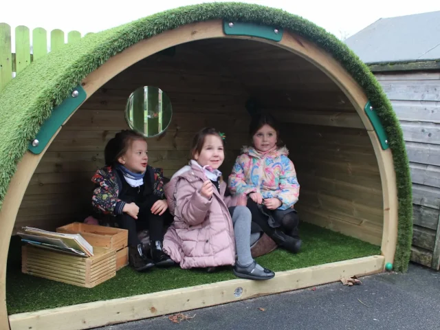 Children reading together in Hobbit House Den